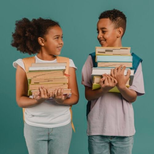 children-holding-piles-books